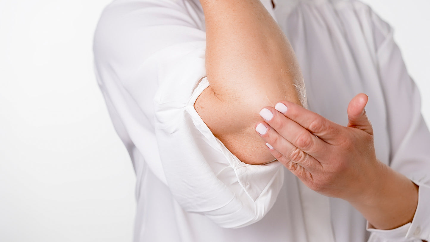woman applying CBD Muscle Balm