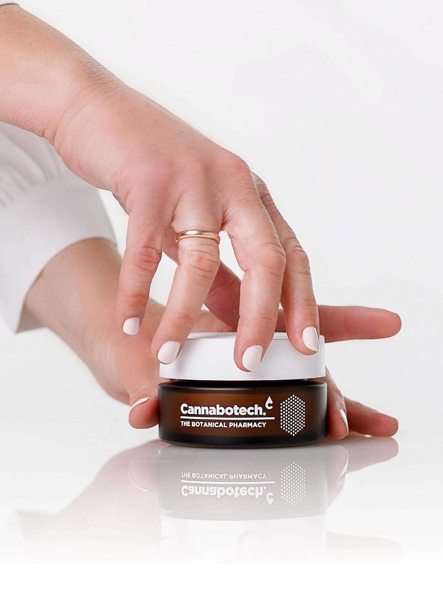 woman opening jar of antioxidant face cream