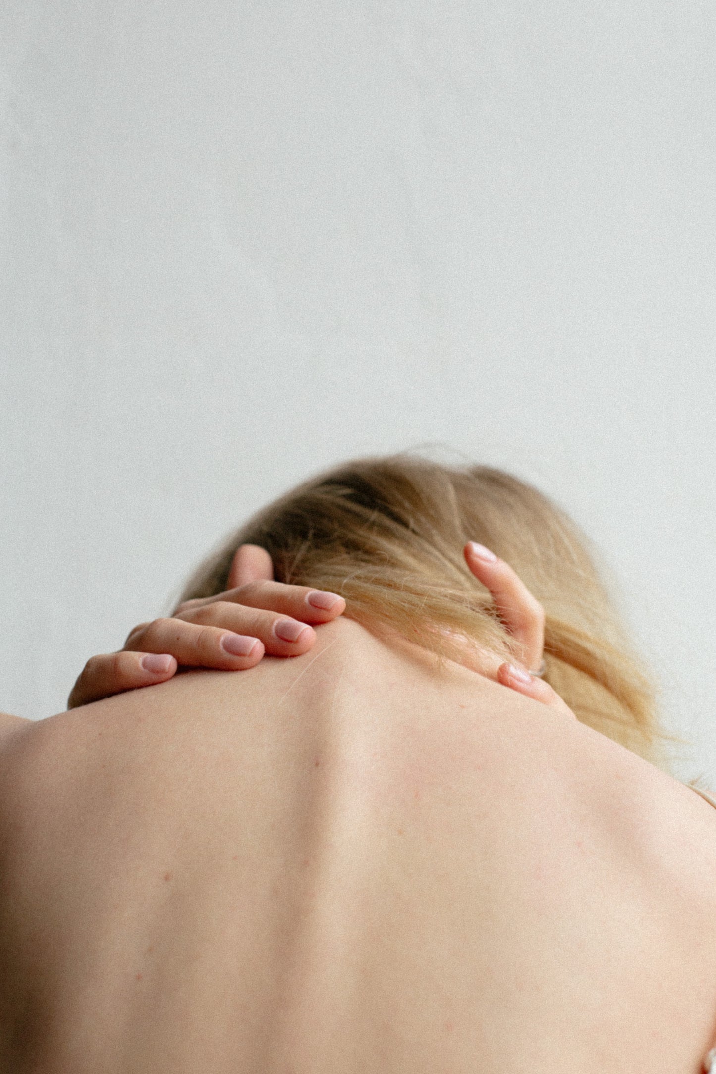 woman applies CBD Balm to her back